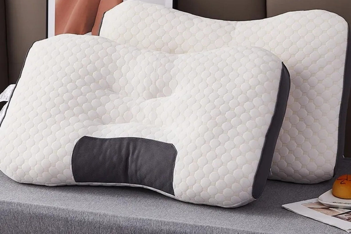 The Loft Pillow on a made bed, seen from the side